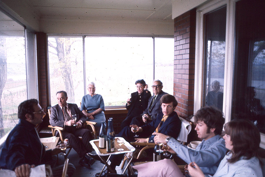 Konstantin and large group on the porch doing a tasting.