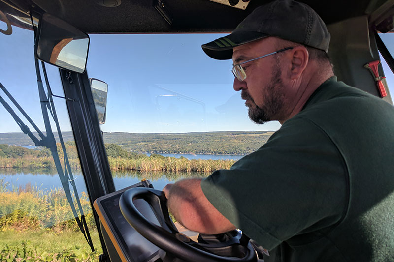 Eric Volz driving a tractor through the vineyards.