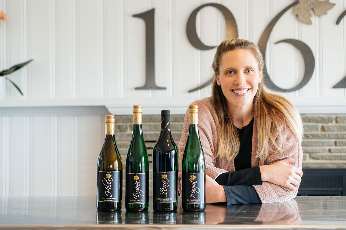 Meaghan Frank with several bottles on a table.