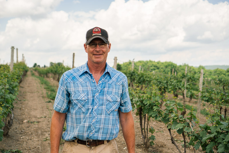 Brien Gardner posing in the vineyards for a picture.