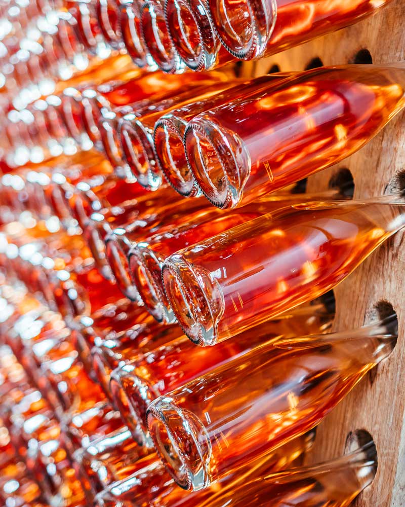 Bottles are being re-fermented in a riddling rack.