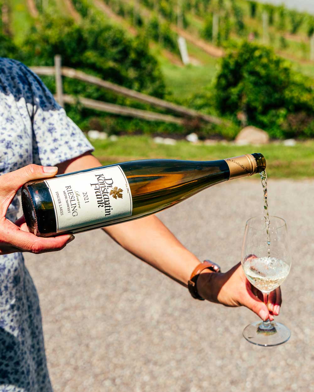 A bottle of Reserve Riesling being poured into a glass.