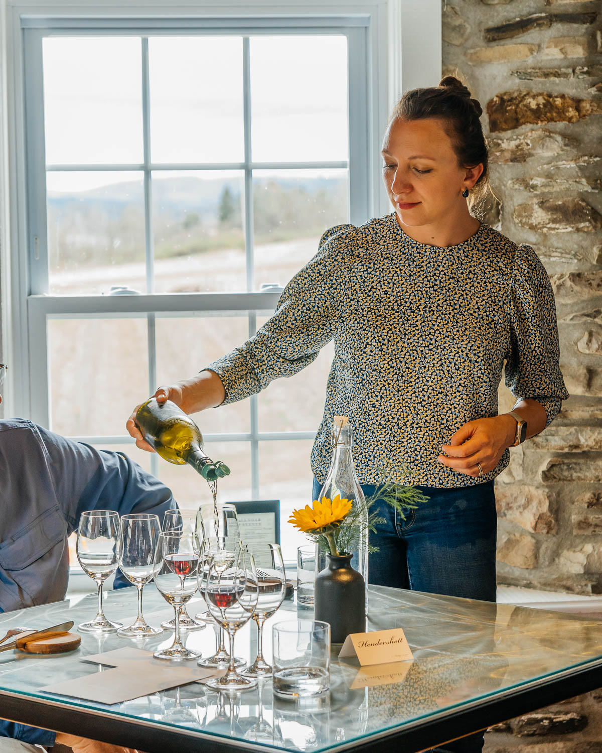 Hospitality Manager Holly Lynn Fusco pouring wine for guests